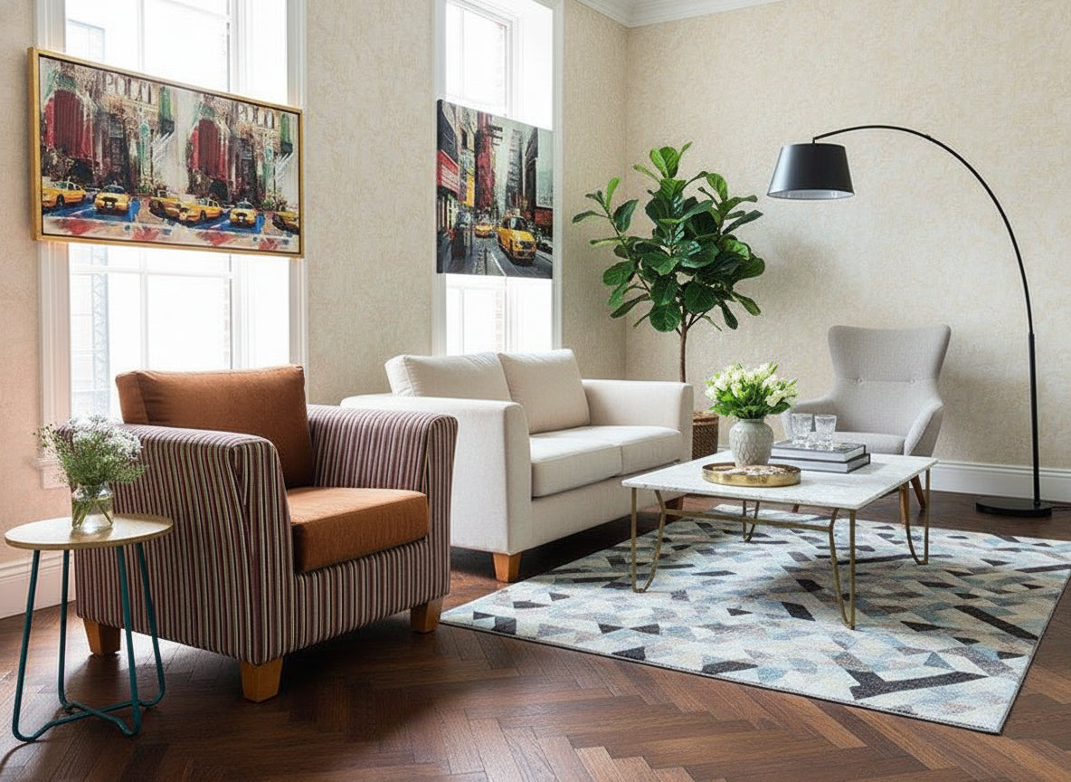 Striped armchair with floral pillow and brown cushion in front of a wooden wall with abstract paintings.